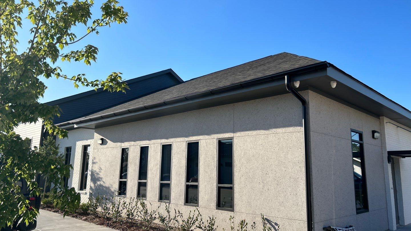 The exterior of a building with windows and a roof.