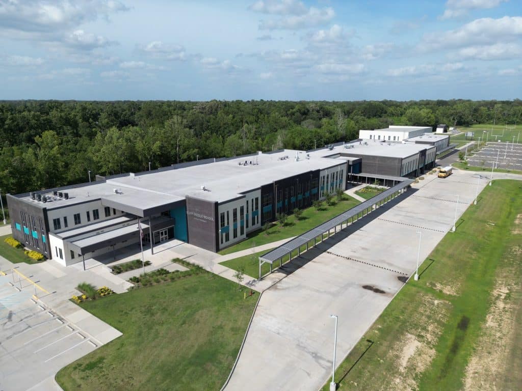 An aerial view of a building in the middle of a field.